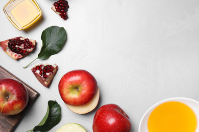 Photo of Honey, apples and pomegranate on light table, flat lay with space for text. Rosh Hashanah holiday