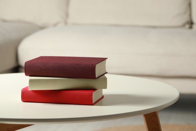 Photo of Many different books stacked on white table indoors, space for text