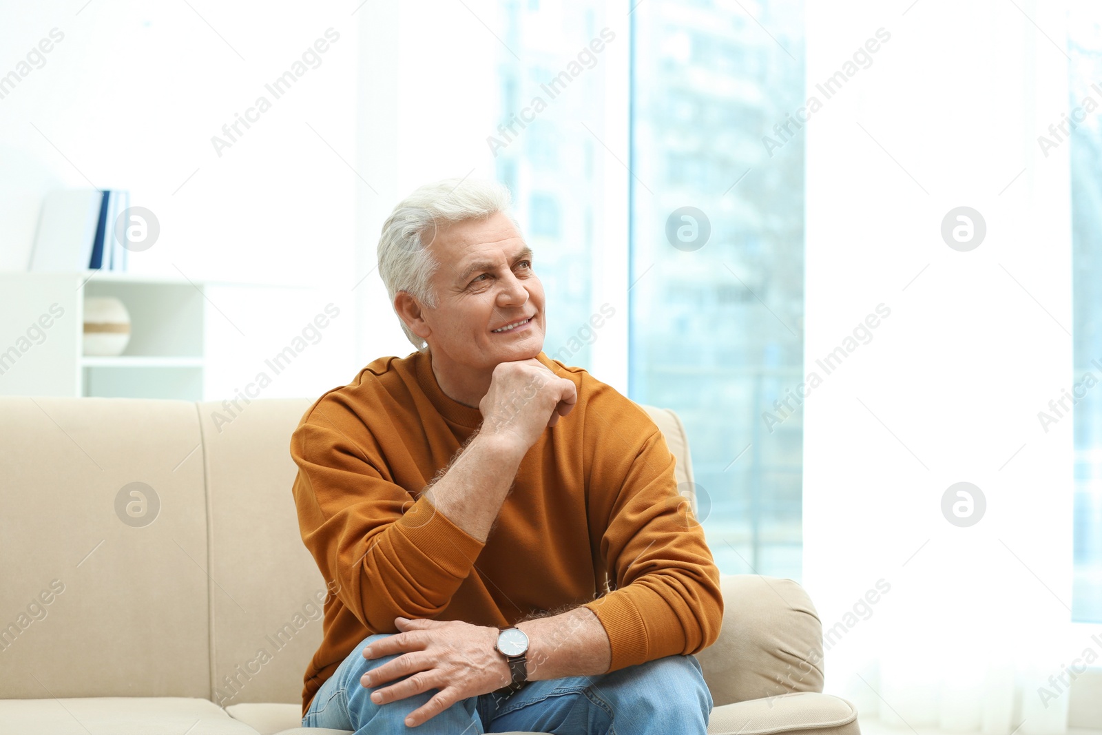 Photo of Portrait of handsome mature man on sofa indoors