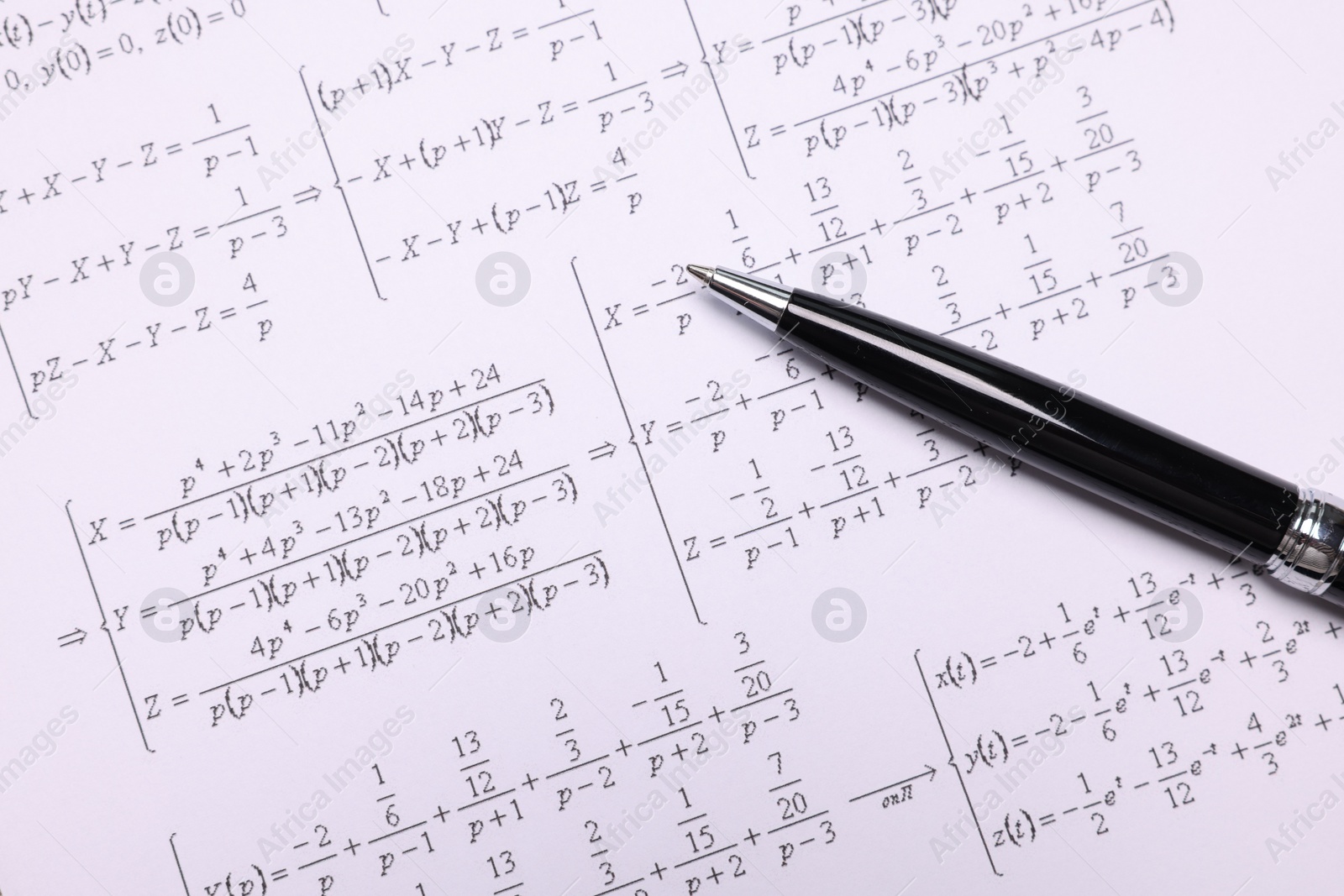 Photo of Sheet of paper with mathematical formulas and pen, top view