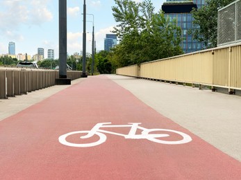 Photo of Bridge with red bicycle lane in city