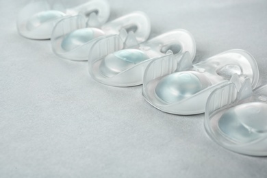 Packages with contact lenses on light background