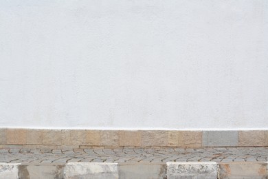 Building with light grey concrete wall on city street