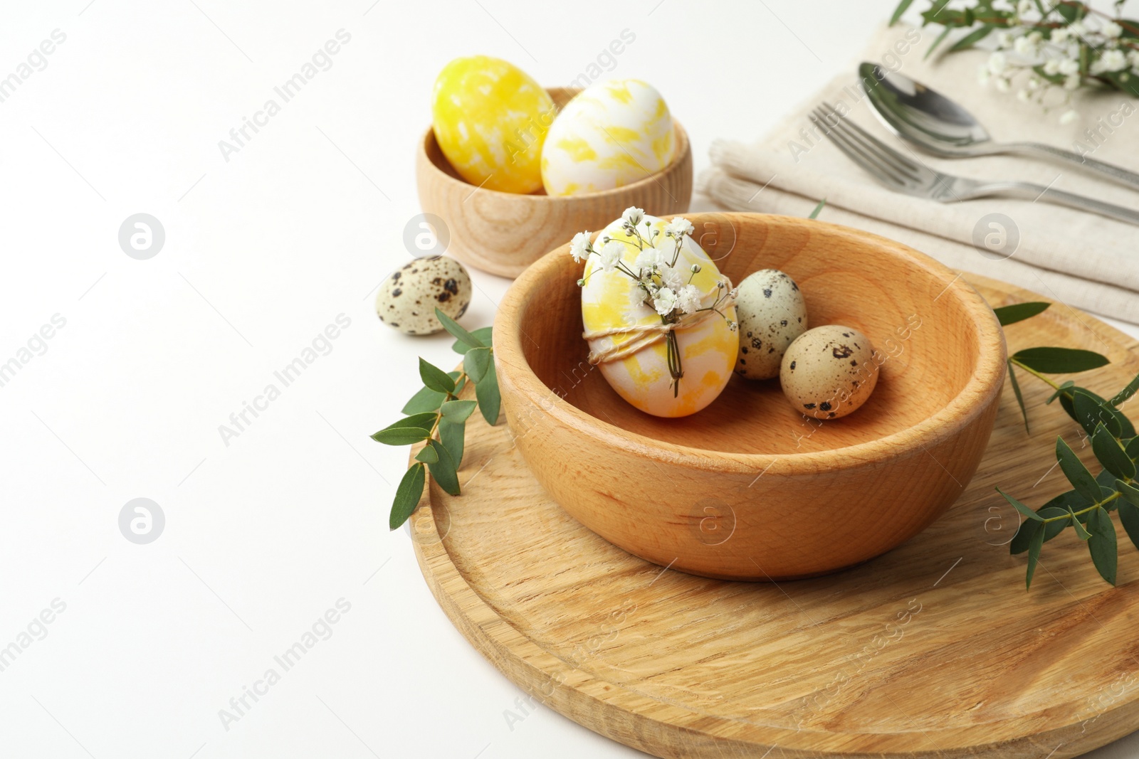 Photo of Festive Easter table setting with eucalyptus and eggs
