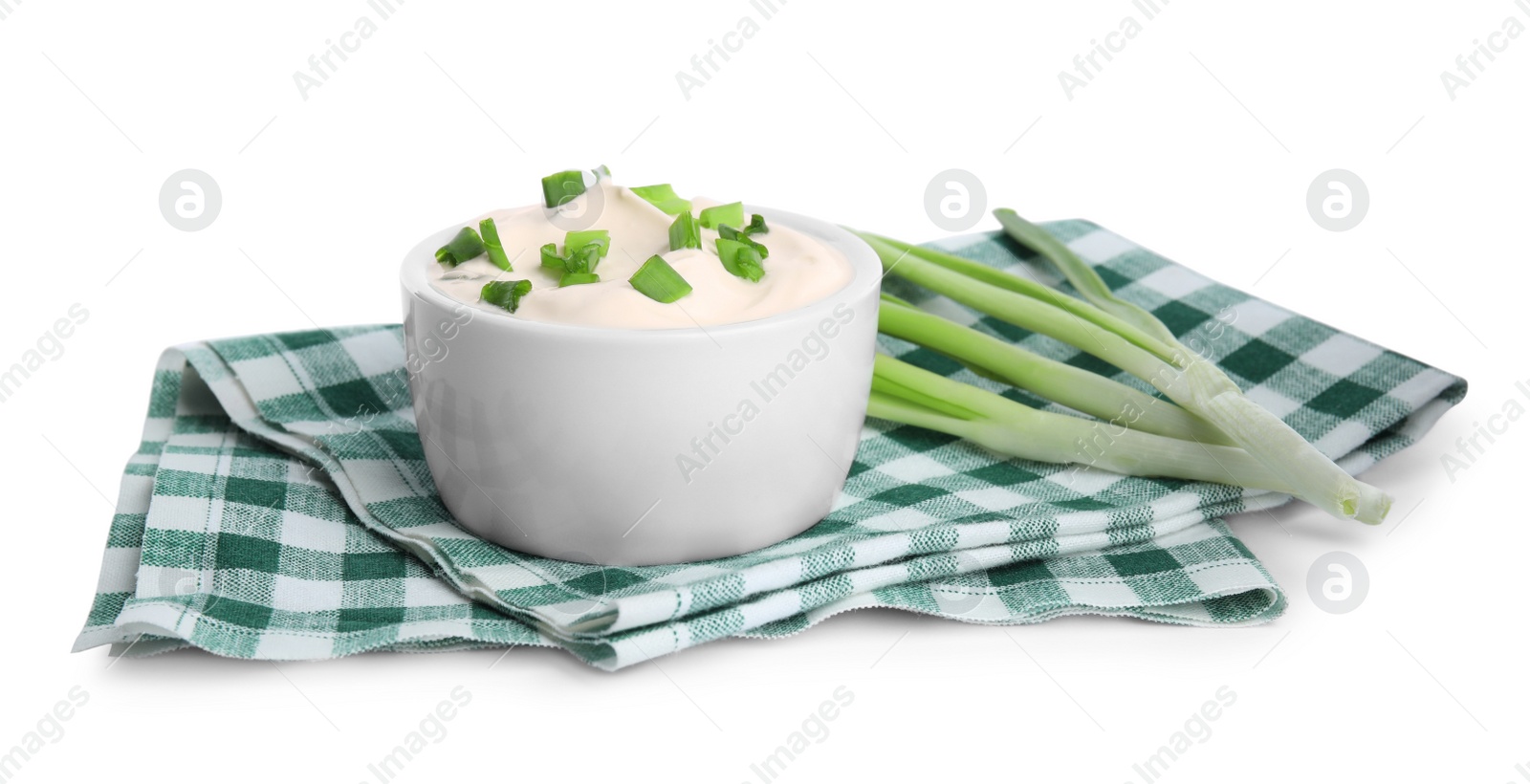 Photo of Fresh sour cream with onion and fabric on white background