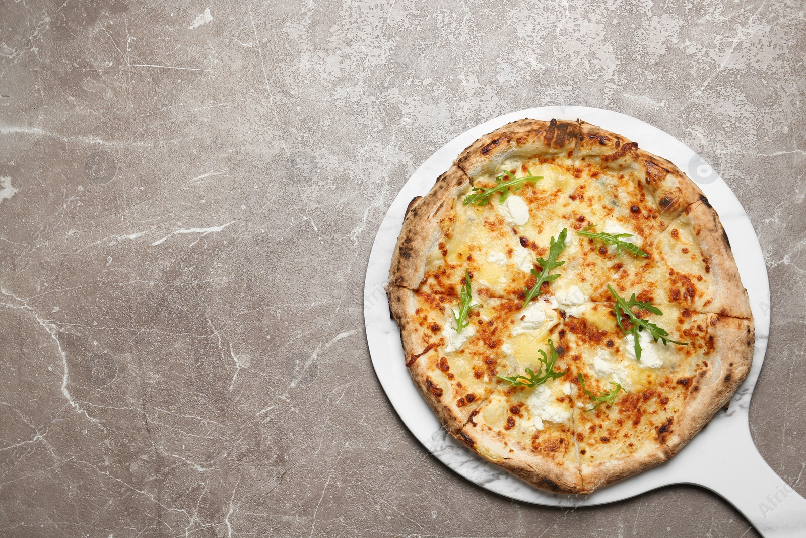 Image of Tasty cheese pizza on grey marble table, top view. Space for text