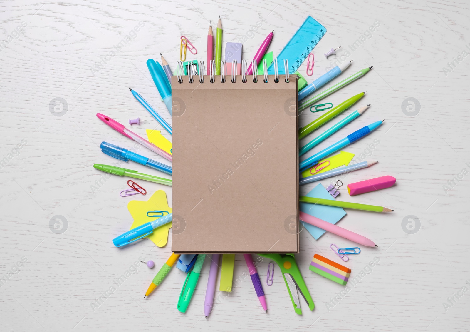 Photo of Blank notebook and stationery on wooden table, flat lay