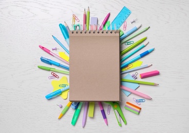 Blank notebook and stationery on wooden table, flat lay