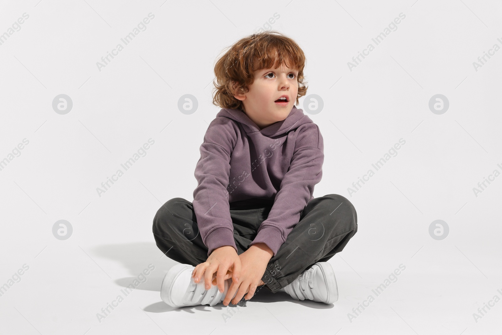 Photo of Fashion concept. Stylish boy posing on white background