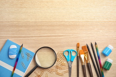 Photo of Different school stationery with space for design on wooden background, flat lay