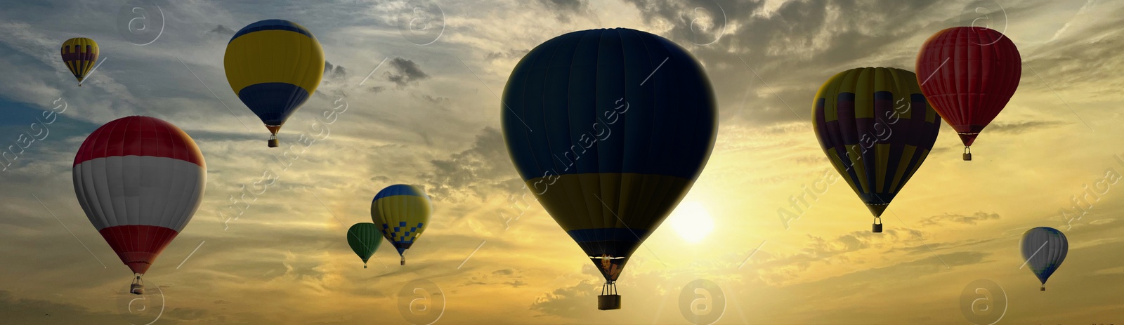 Image of Many bright hot air balloons flying in sunset sky, banner design