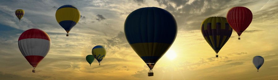 Image of Many bright hot air balloons flying in sunset sky, banner design