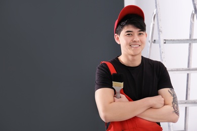 Portrait of male decorator with brush indoors