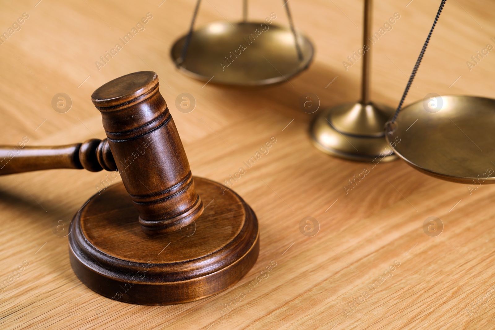 Photo of Wooden gavel and scales of justice on table. Space for text