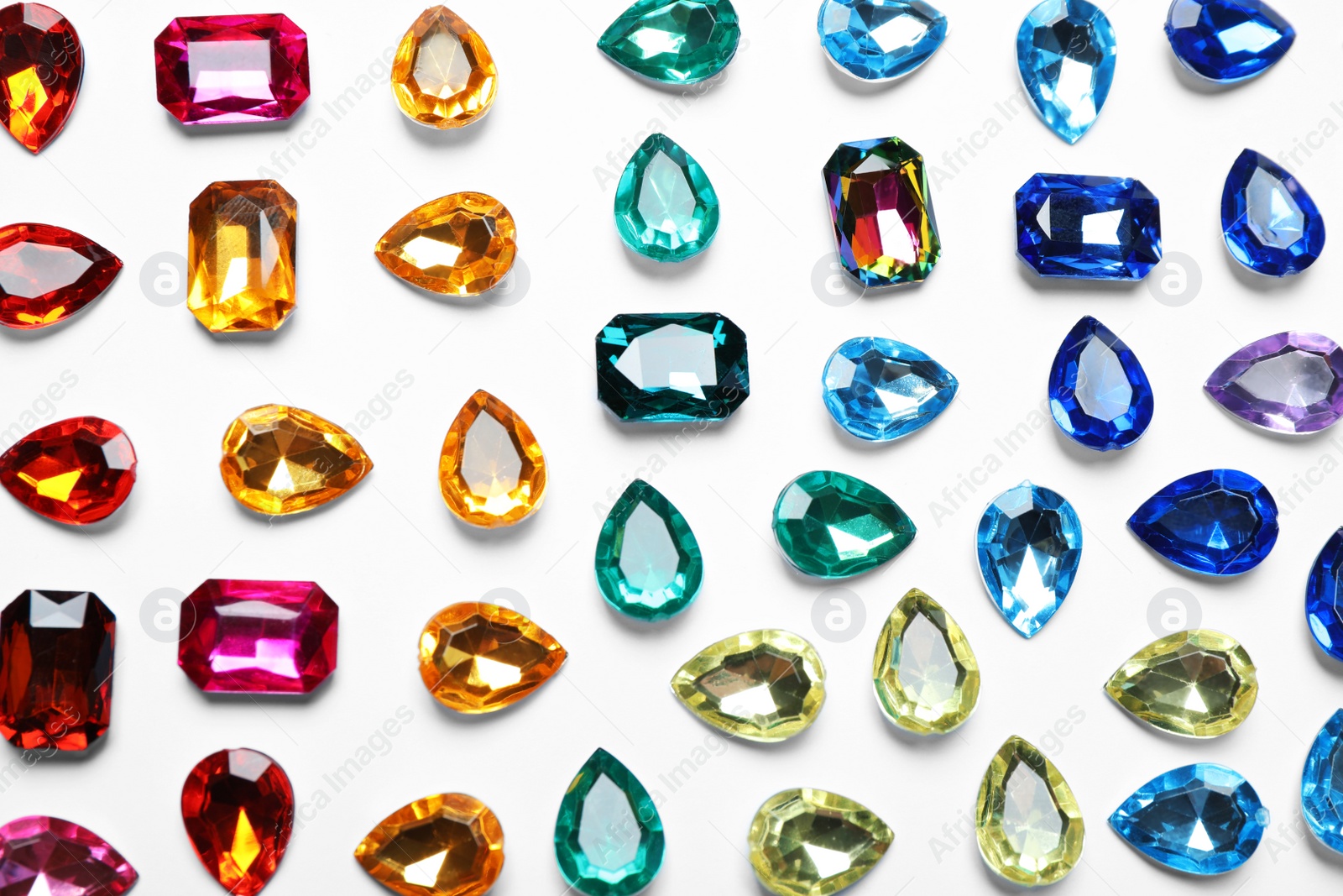 Photo of Different beautiful gemstones on white background, top view