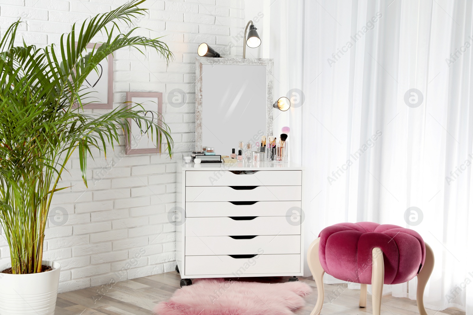 Photo of Interior of light room with dressing table near wall