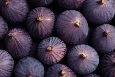 Fresh ripe figs as background, top view. Tropical fruit