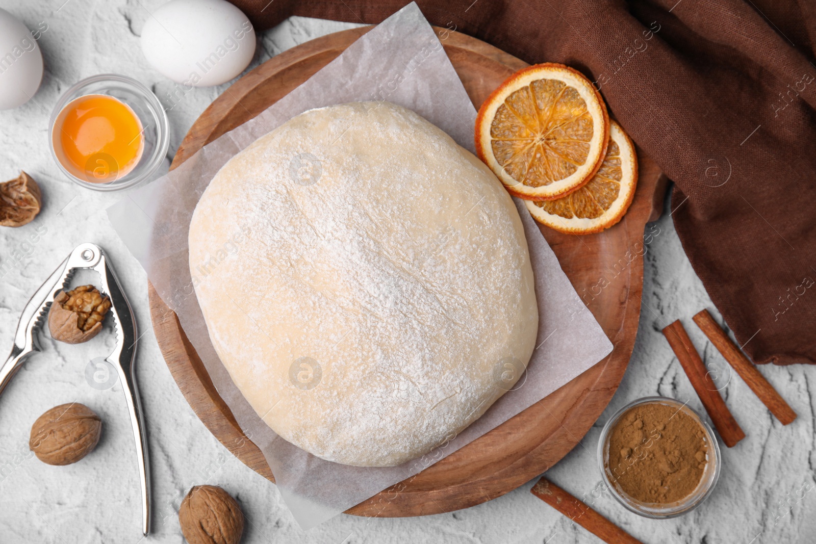 Photo of Fresh dough and ingredients on white table, flat lay