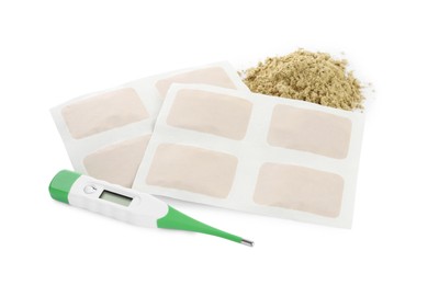 Mustard powder, plasters and thermometer on white background