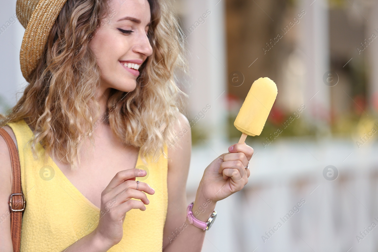 Photo of Happy young woman with delicious ice cream outdoors, closeup. Space for text