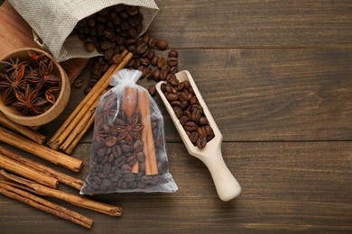 Photo of Scented sachet with coffee beans, anise and cinnamon on wooden table, flat lay. Space for text
