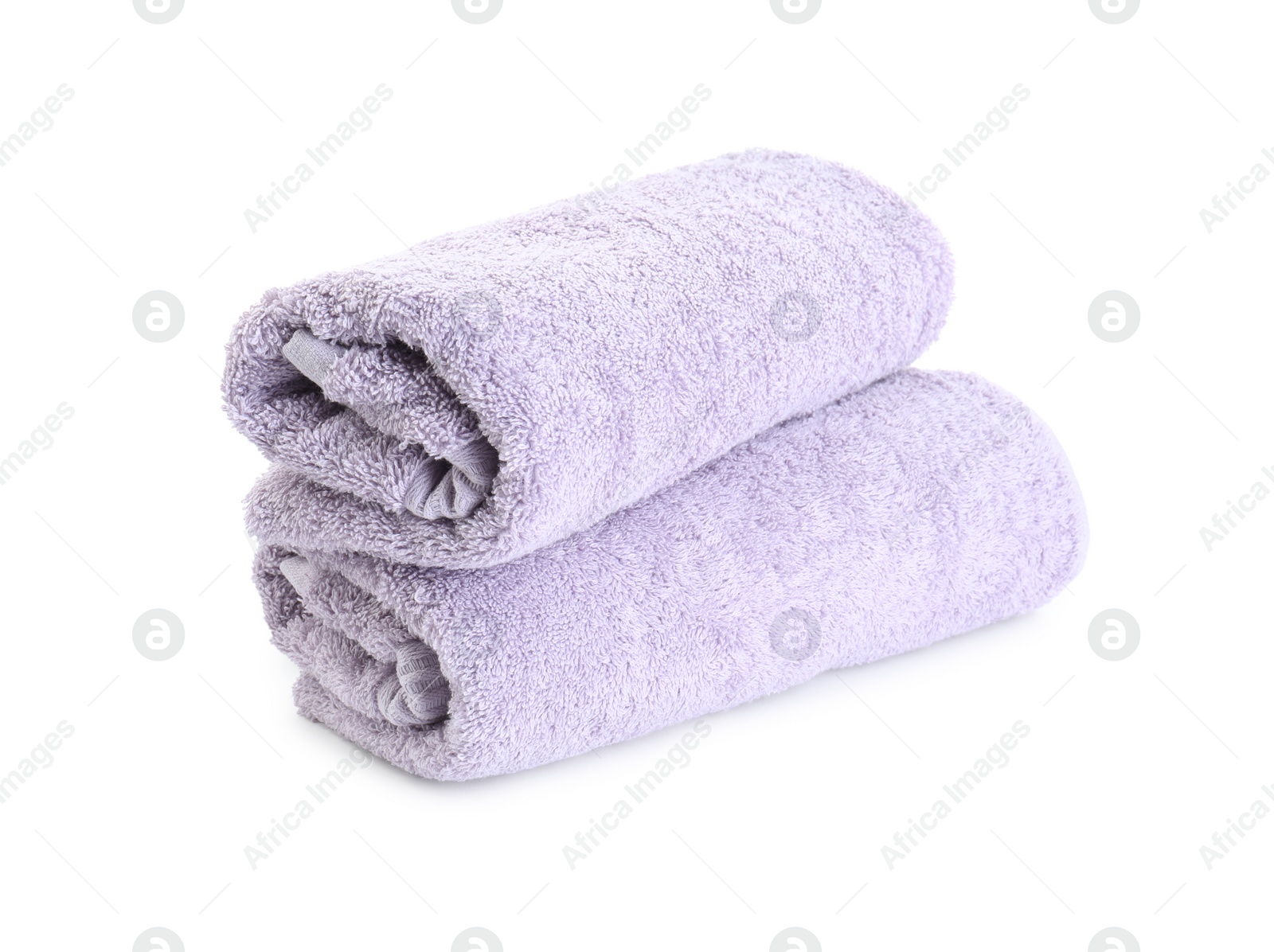 Photo of Rolled violet terry towels isolated on white