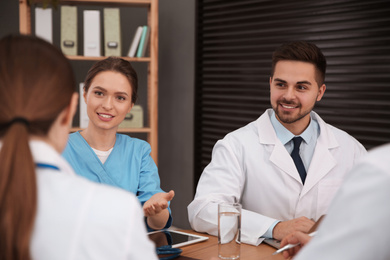 Team of professional doctors having meeting in office