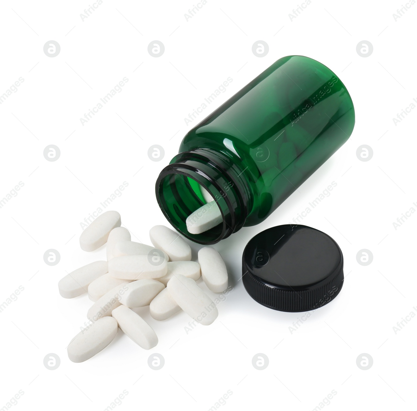 Photo of Scattered vitamin pills and bottle isolated on white