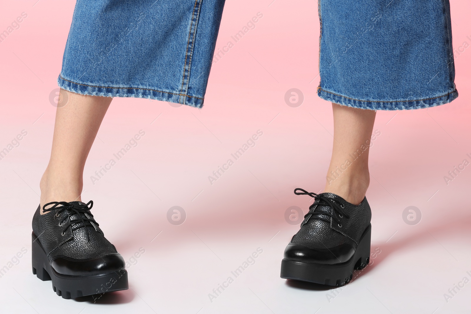 Photo of Woman in stylish shoes on color background, closeup