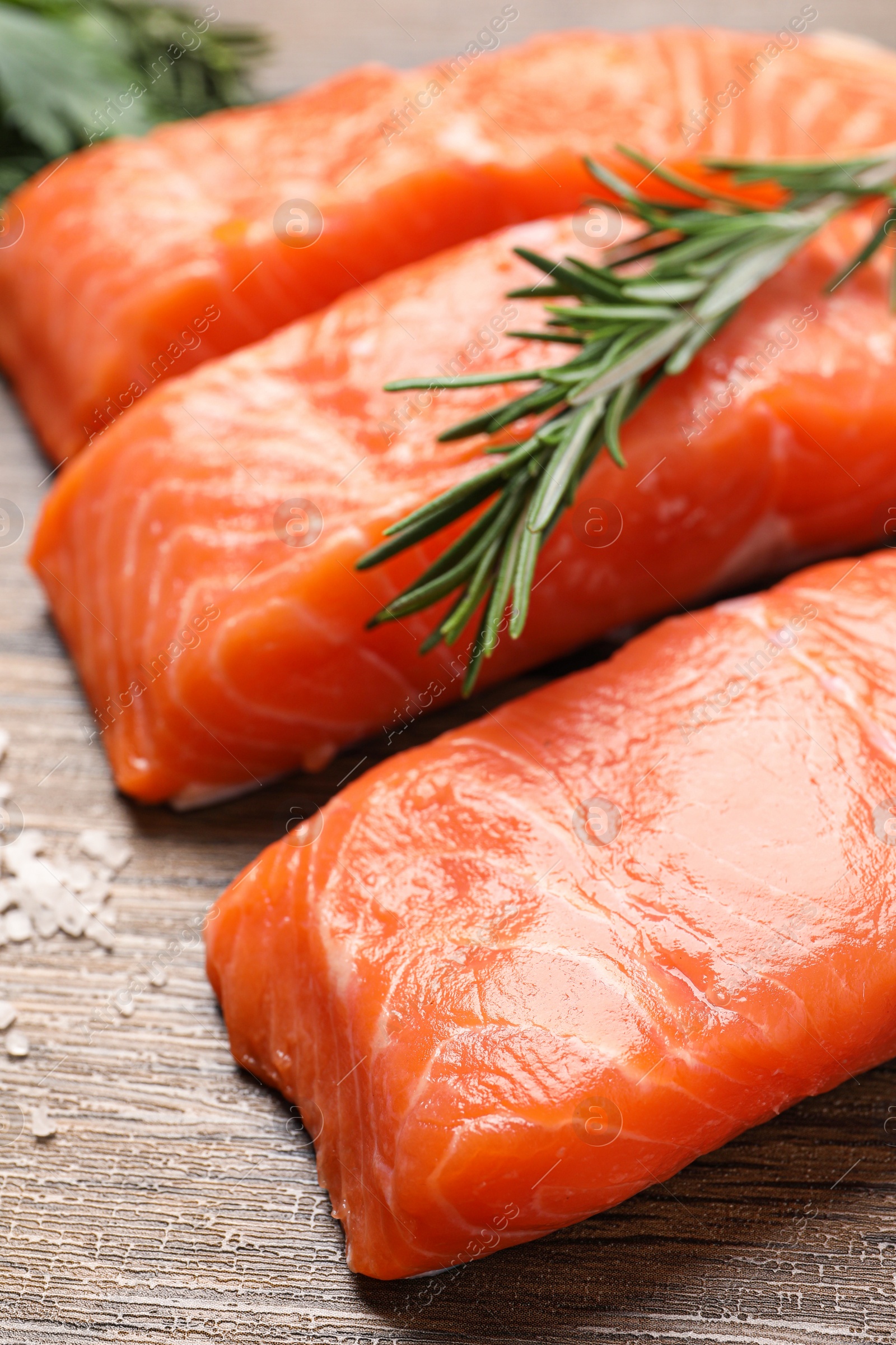 Photo of Fresh salmon and ingredients for marinade on wooden table, closeup