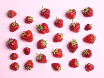 Photo of Tasty ripe strawberries on pink background, flat lay