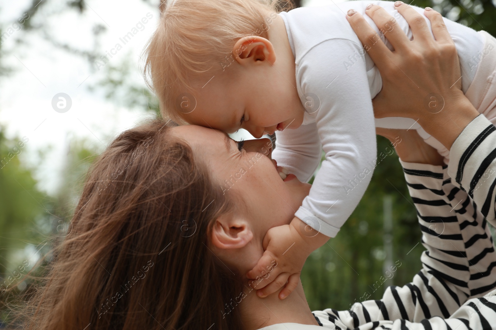 Photo of Mother with her cute baby spending time together outdoors