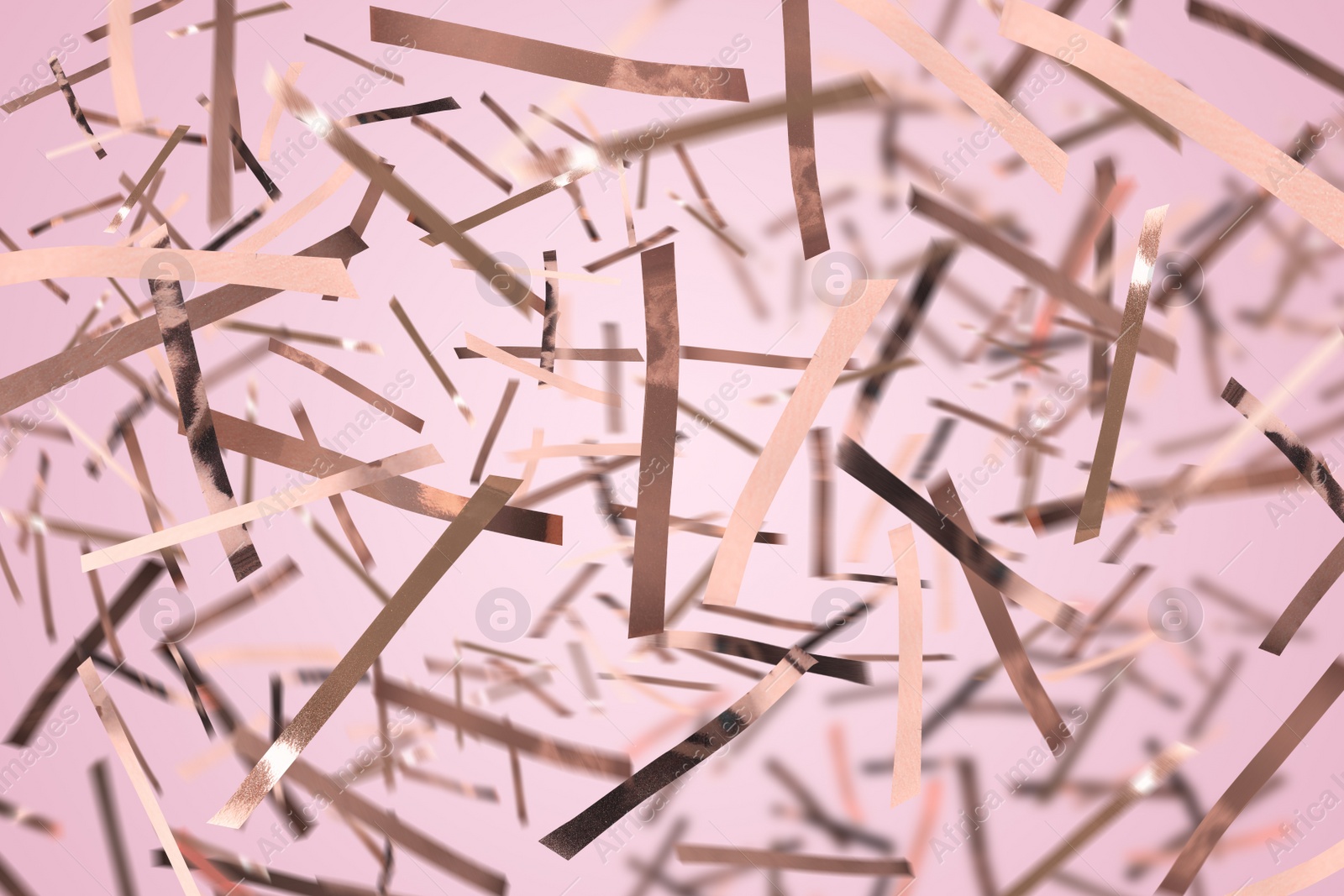 Image of Shiny confetti falling down on light pink background