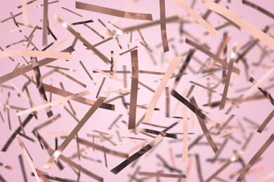 Image of Shiny confetti falling down on light pink background