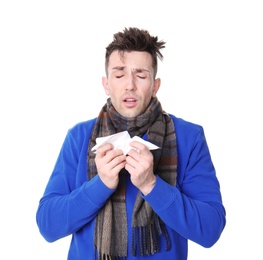 Photo of Young man with cold sneezing on white background