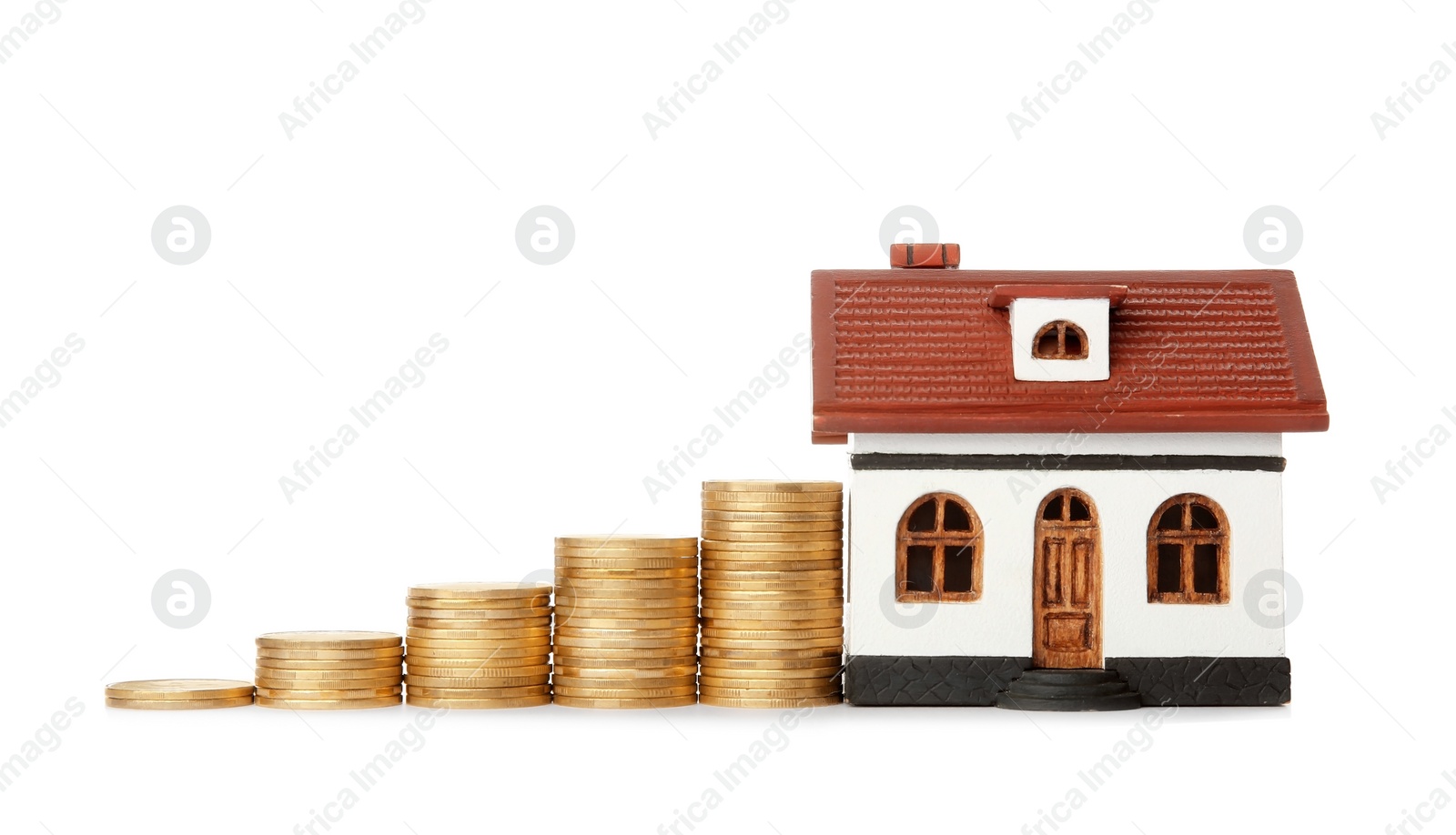 Photo of House model and coins on white background. Heating price concept