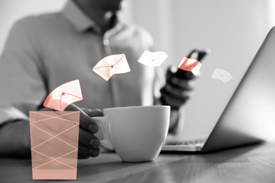 Man drinking coffee while working at table, closeup. Envelopes flying from laptop into trash bin, illustration of spam removing