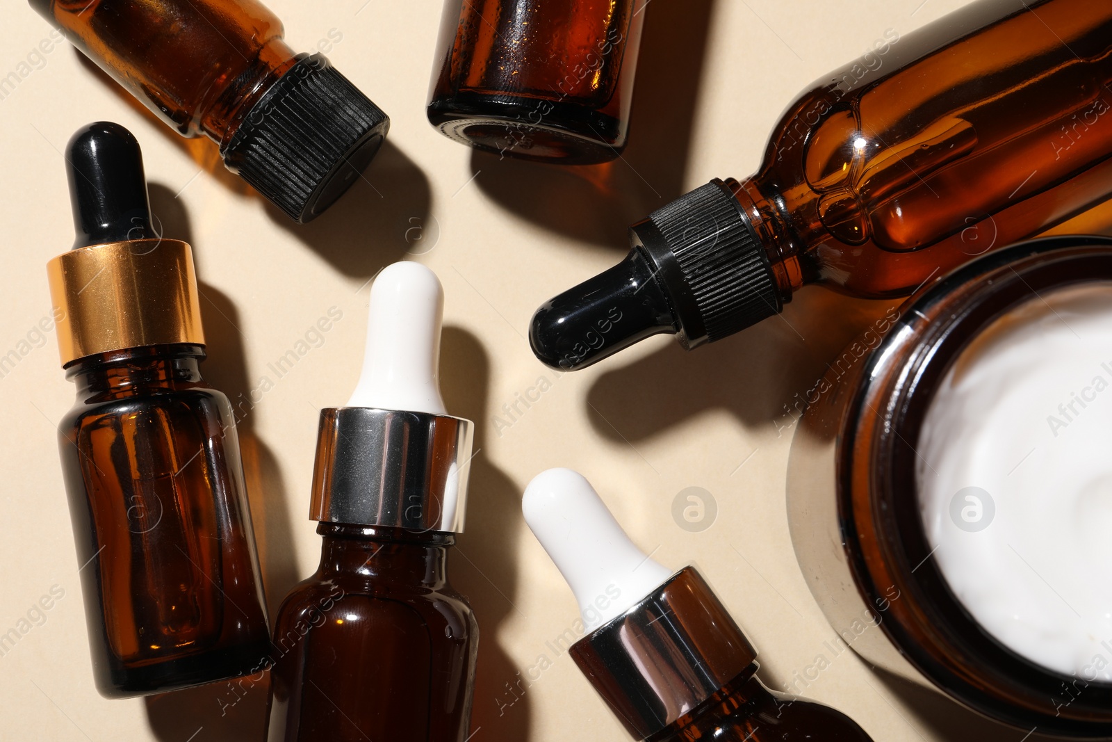 Photo of Cosmetic serum on beige background, flat lay