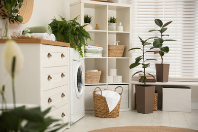 Photo of Elegant interior of modern bathroom with green plants