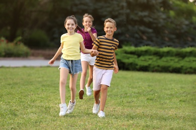 Cute smiling little children playing in park