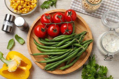 Photo of Fresh green beans and other ingredients for salad on white wooden table, flat lay