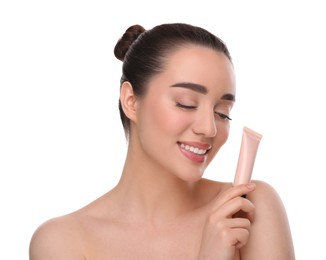 Photo of Woman holding tube of foundation on white background