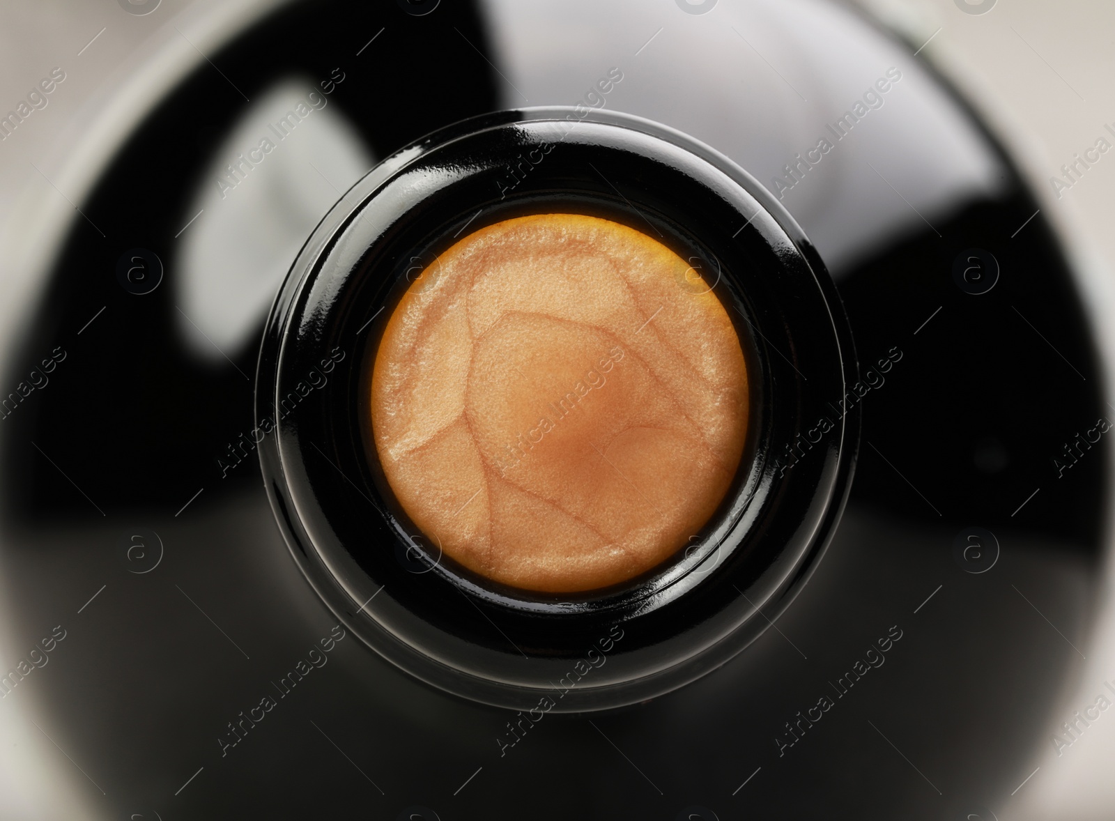 Photo of Closeup view of cork in wine bottle on grey background