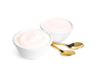 Photo of Tasty organic yogurt in bowls and spoons isolated on white