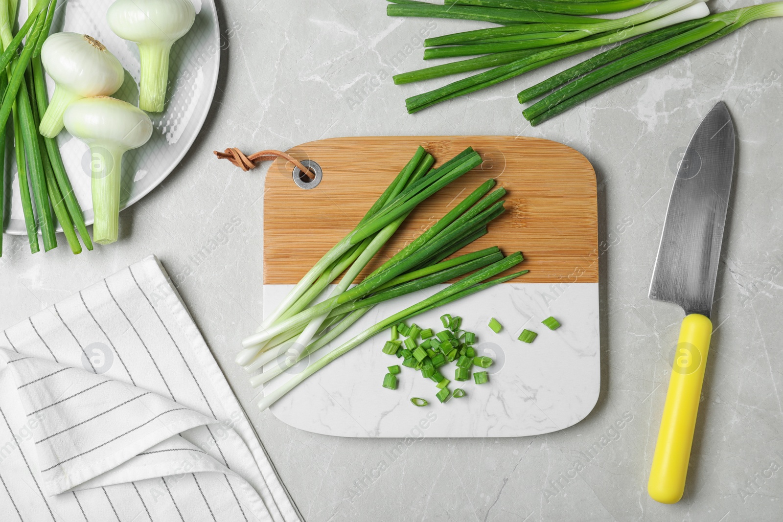 Photo of Flat lay composition with fresh green onion on marble background