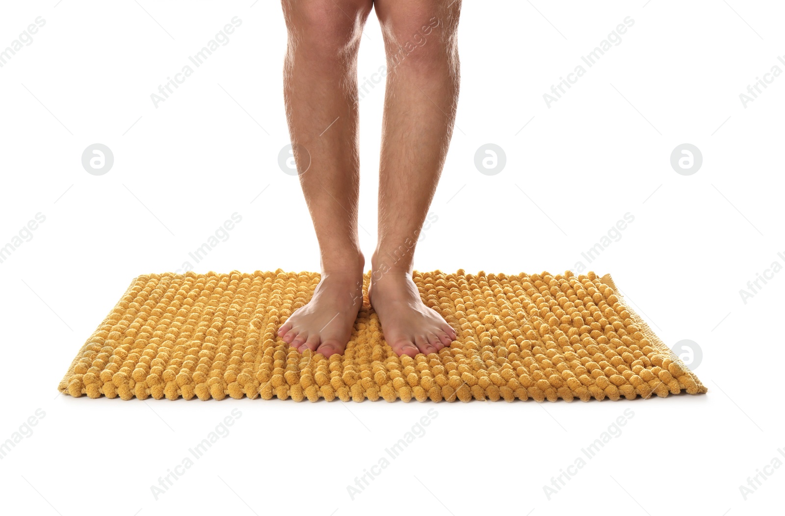 Photo of Man standing on soft orange bath mat against white background, closeup