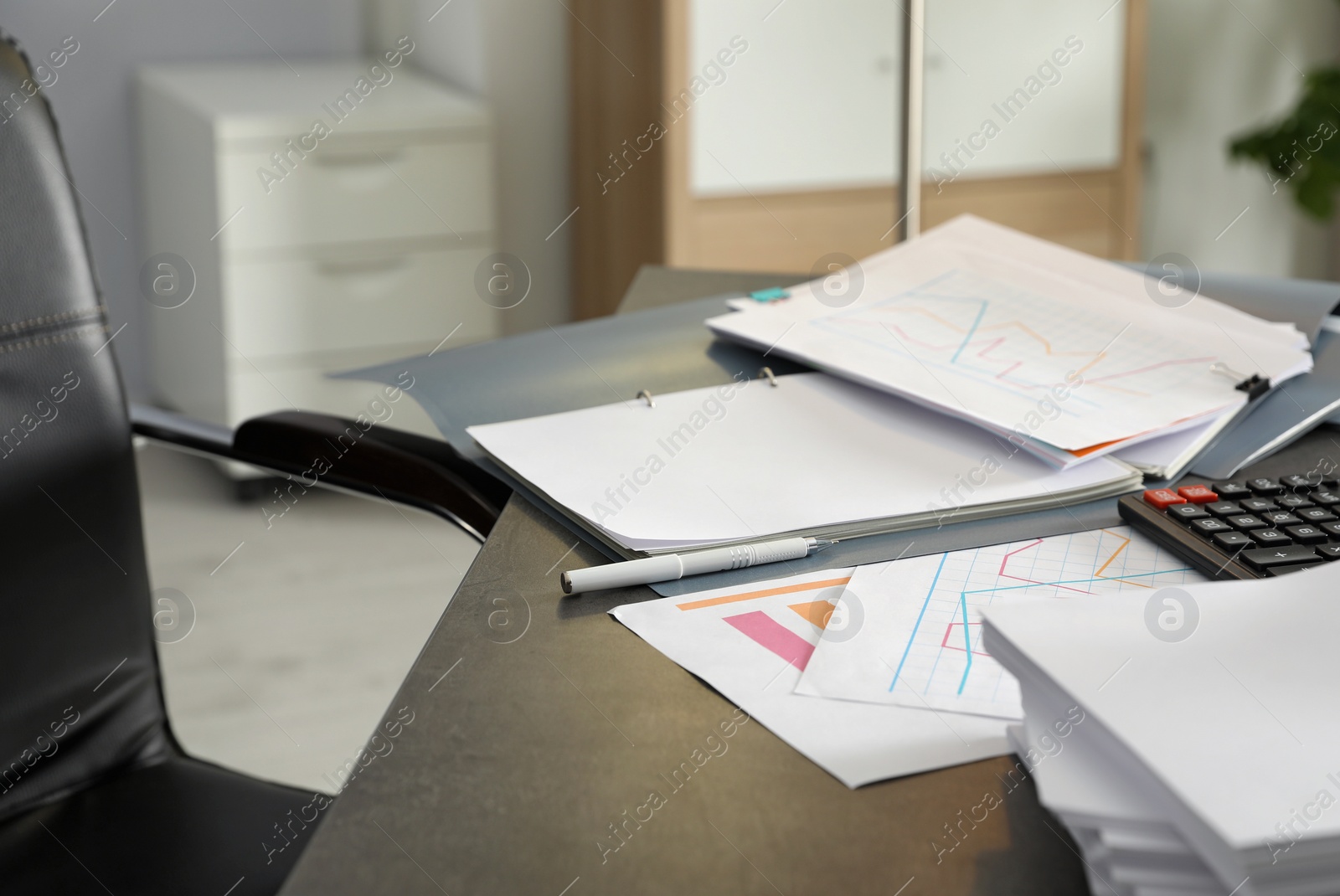 Photo of Pen, different documents and calculator on office table