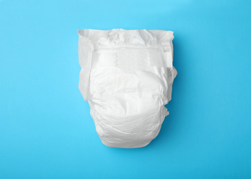 Baby diaper on light blue background, top view