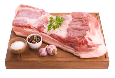 Photo of Piece of raw pork belly, parsley, garlic and spices isolated on white