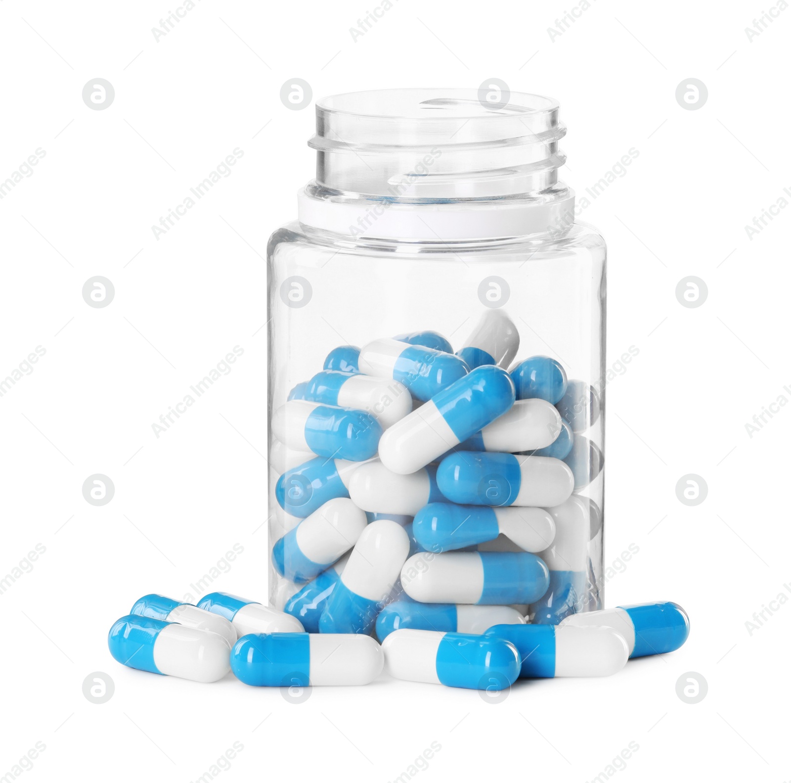 Photo of Antibiotic pills and bottle isolated on white